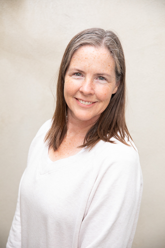 gray haired, kind woman in cream sweater